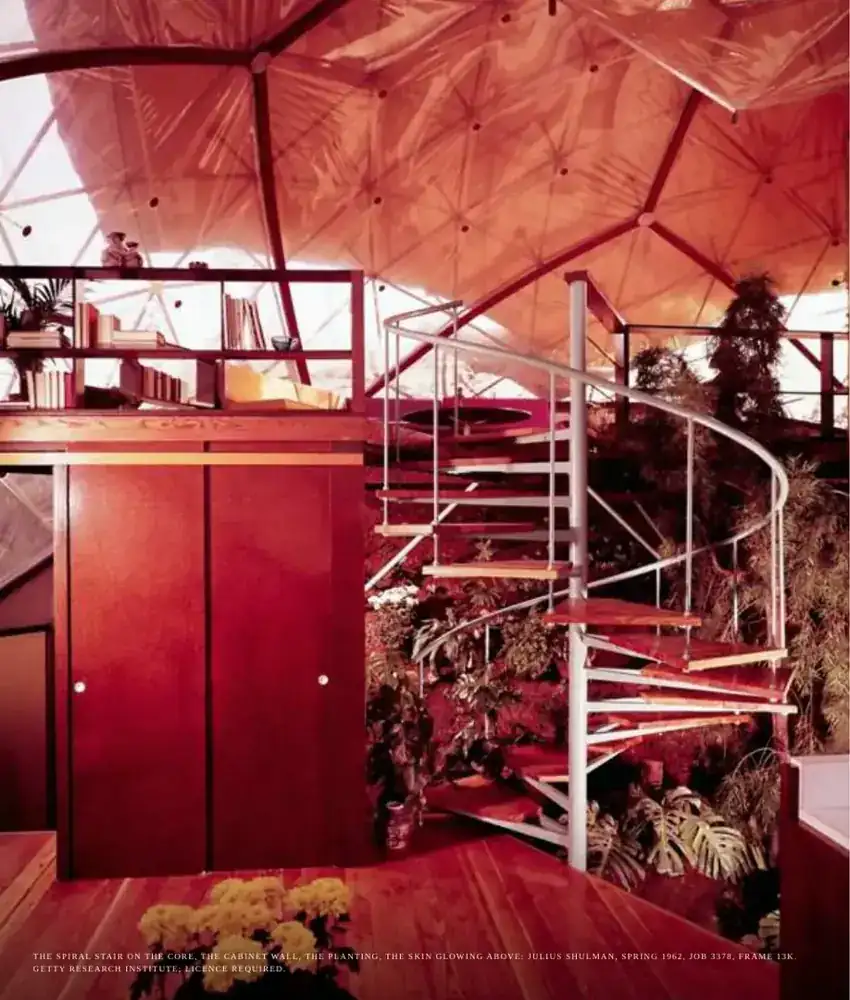 A red spiral stair under the glowing skin of the dome